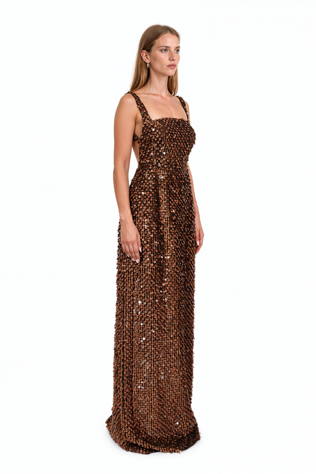 Side view of a Valentino brown paillette column gown showing the narrow floor-length silhouette