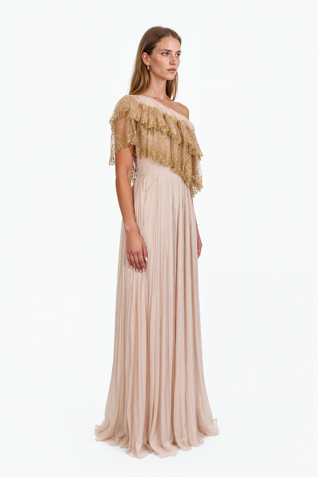 Side view of a Valentino blush pleated chiffon gown with tiered gold lace shoulder ruffle