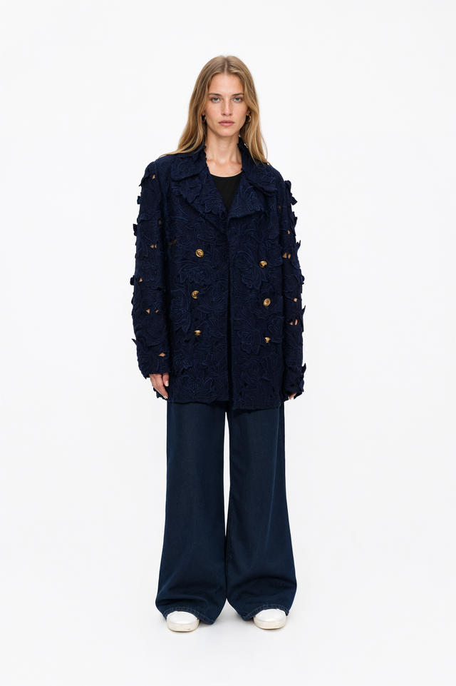 Back view of a Valentino navy wool peacoat with floral cutwork embroidery