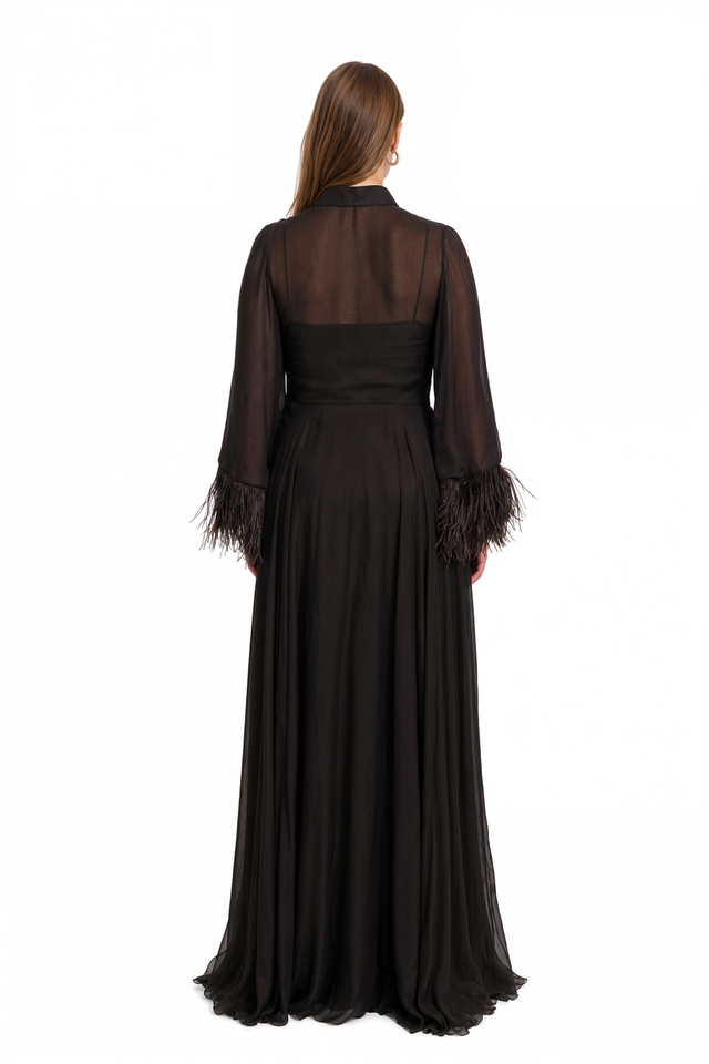Back view of a Valentino black chiffon gown with feather cuffs and full skirt