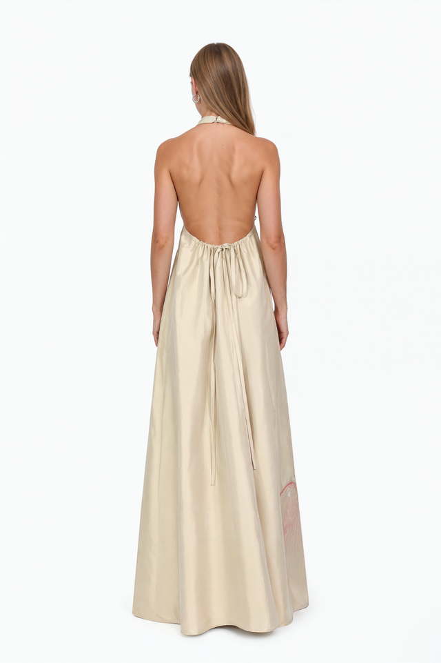 Back view of a Valentino ivory halter gown showing the open back and neck tie