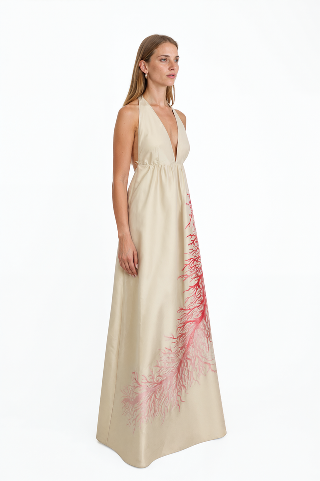 Side view of a Valentino ivory coral-print halter gown with full floor-length skirt