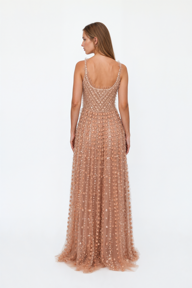 Back view of a Valentino sequin floret tulle gown with scooped back and ruffled hem