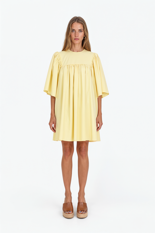 Red Valentino babydoll mini dress with gathered waist and flowing skirt.