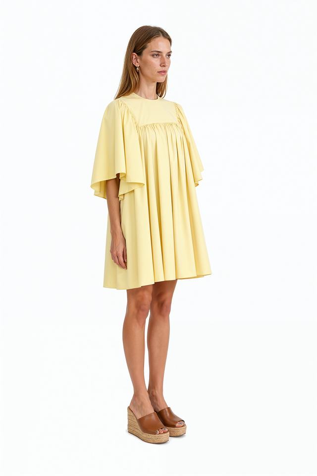 Red Valentino babydoll mini dress with gathered waist and flowing skirt.