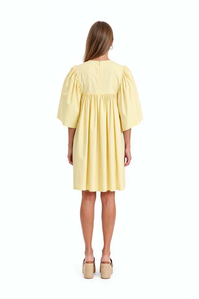 Red Valentino babydoll mini dress with gathered waist and flowing skirt.
