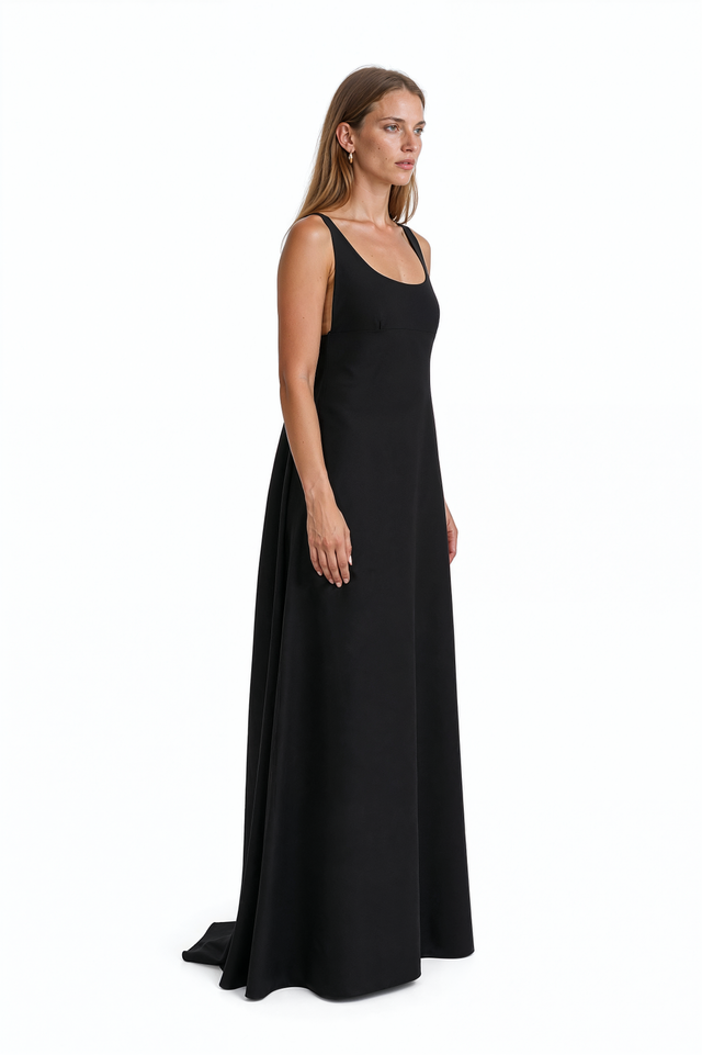 Side view of a Valentino black crepe A-line gown showing the floor-length skirt