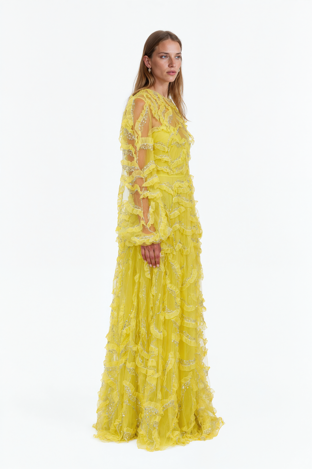 Side view of a Valentino yellow ruffle-trimmed tulle gown with full A-line skirt