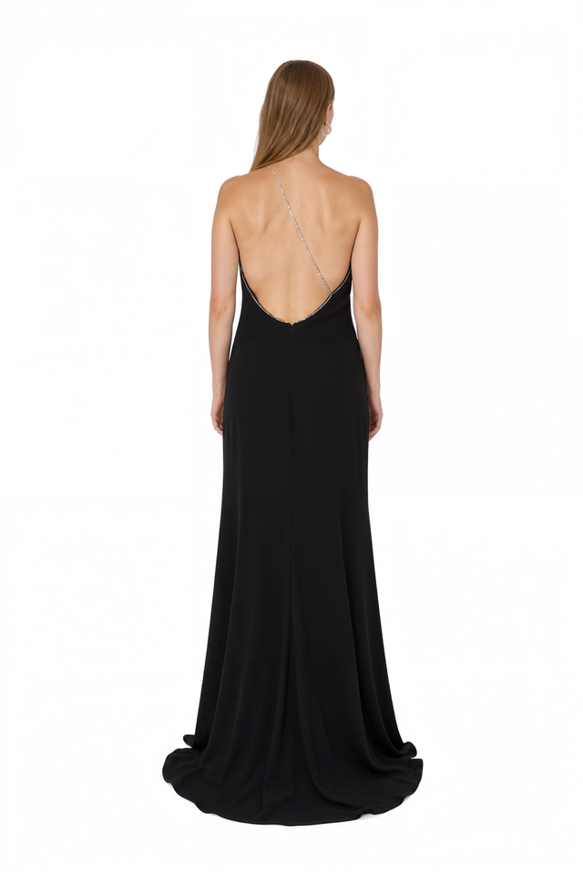 Back view of a Valentino black one-shoulder gown with back slit