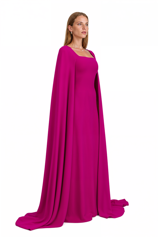 Three-quarter view of Valentino magenta silk cape gown showing the sweeping cape train