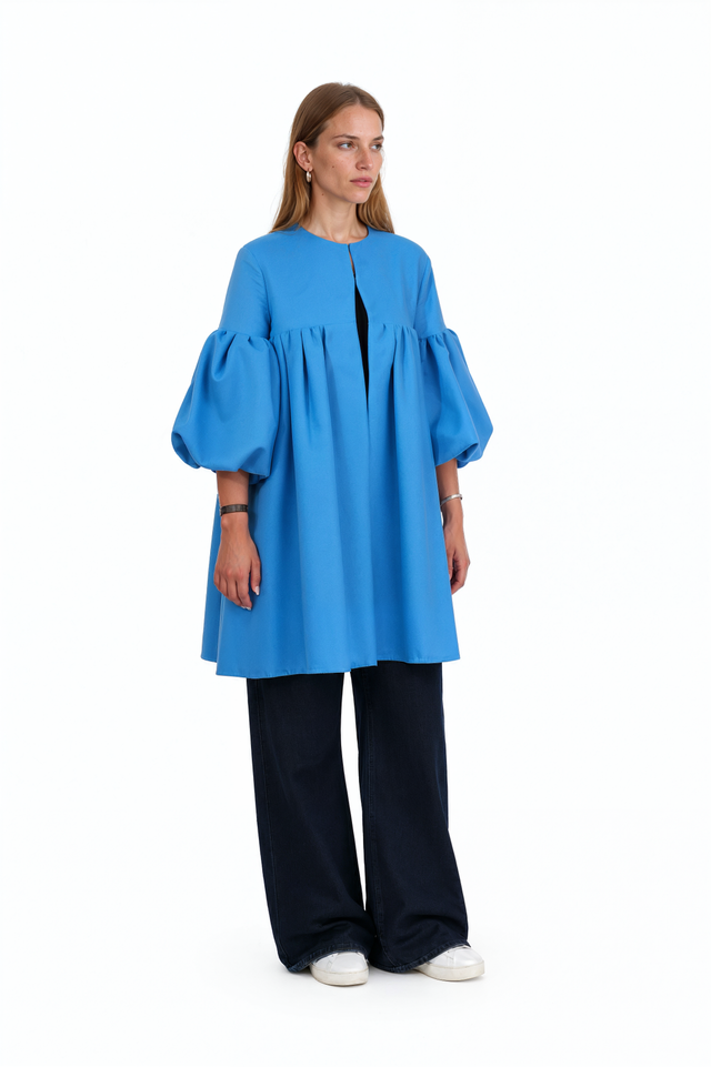 Side view of a Valentino blue A-line swing coat showing the sleeve volume