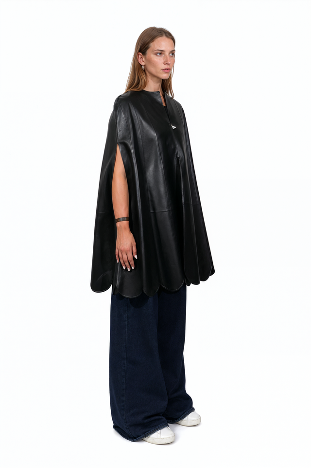 Side view of a Valentino scalloped black leather cape