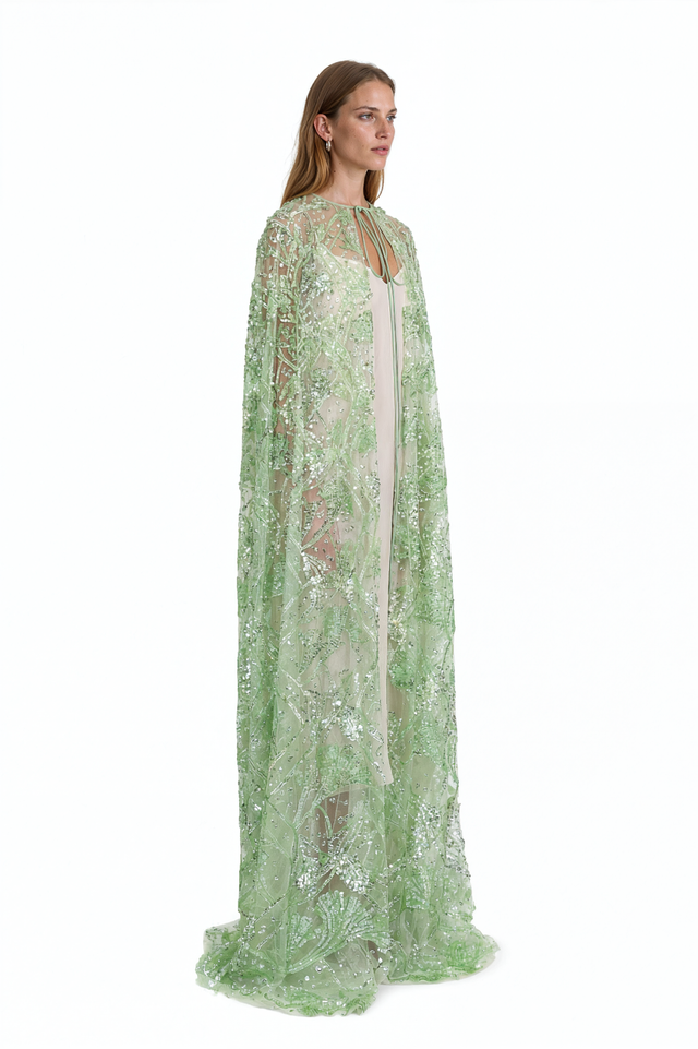 Side view of a Valentino green beaded sheer cape showing the trailing floor-length panels