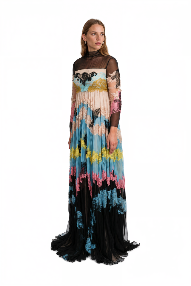 Side view of a Valentino sheer lace panel gown with pleated skirt