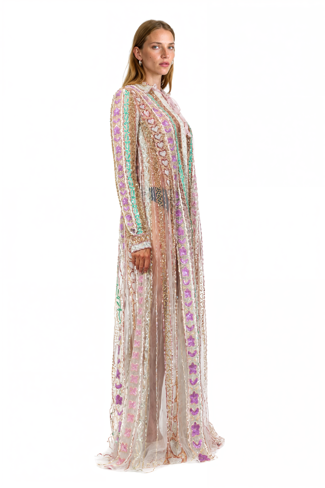 Side view of a Valentino ivory heart-embroidered sheer shirt gown