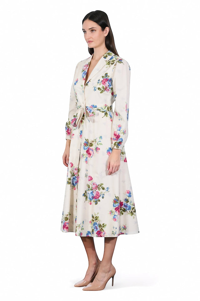 MSA Haute Couture cream midi dress with a floral print of pink and blue roses, featuring a shirt collar, long sleeves, and a waist tie.