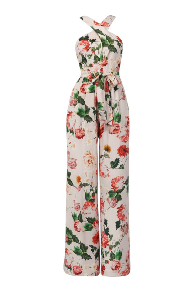MSA Haute Couture ivory floral jumpsuit with cross-neck halter, tie waist, and wide-leg trousers. Red and green floral print.