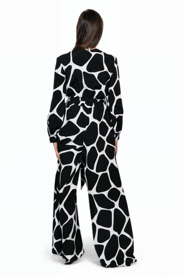 Valentino abstract print jumpsuit, back view on model — black and white wide-leg silhouette with belted waist.